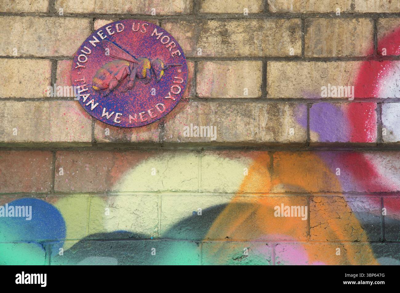 "You need us more than we need you". A plaque highlighting the decline in population of those vital plant pollinators, the Bees. Bristol, England, UK. Stock Photo