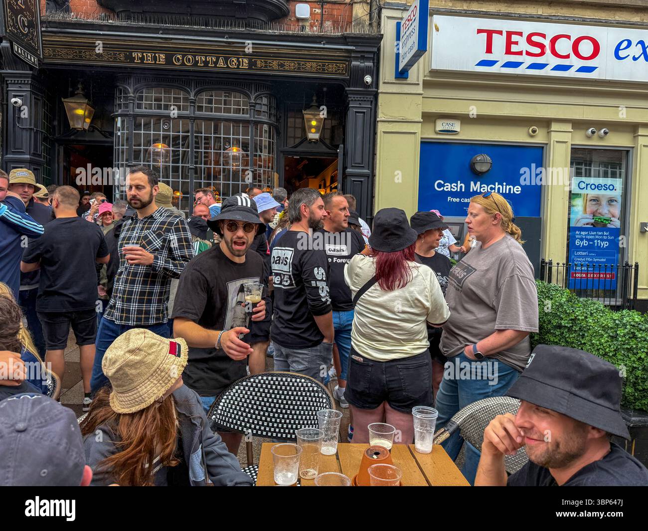 Oasis Fans and Buskers in Cardiff City Centre During Oasis Live ’25 Reunion Tour - Smartphone Captured Stock Image