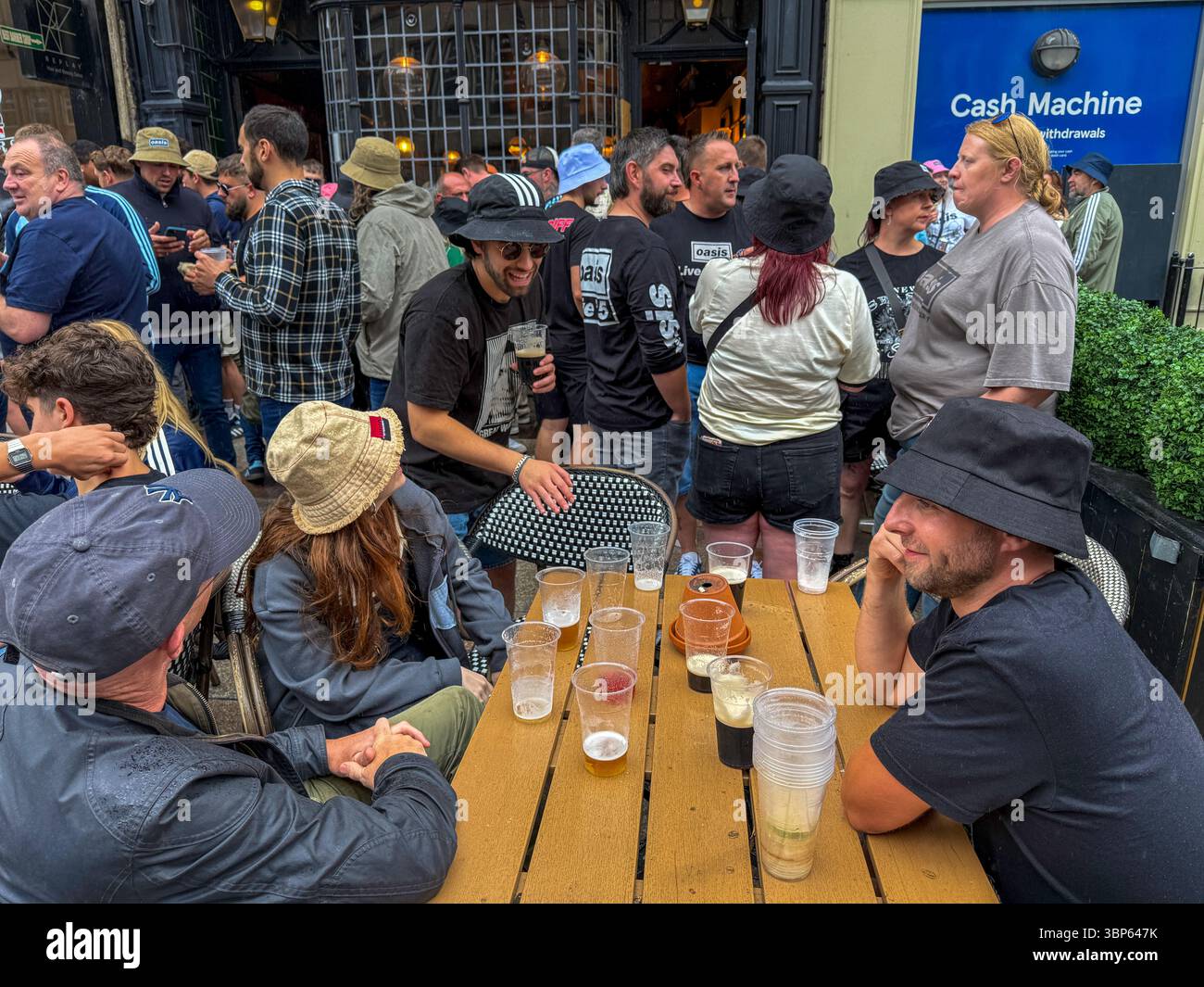 Oasis Fans and Buskers in Cardiff City Centre During Oasis Live ’25 Reunion Tour - Smartphone Captured Stock Image