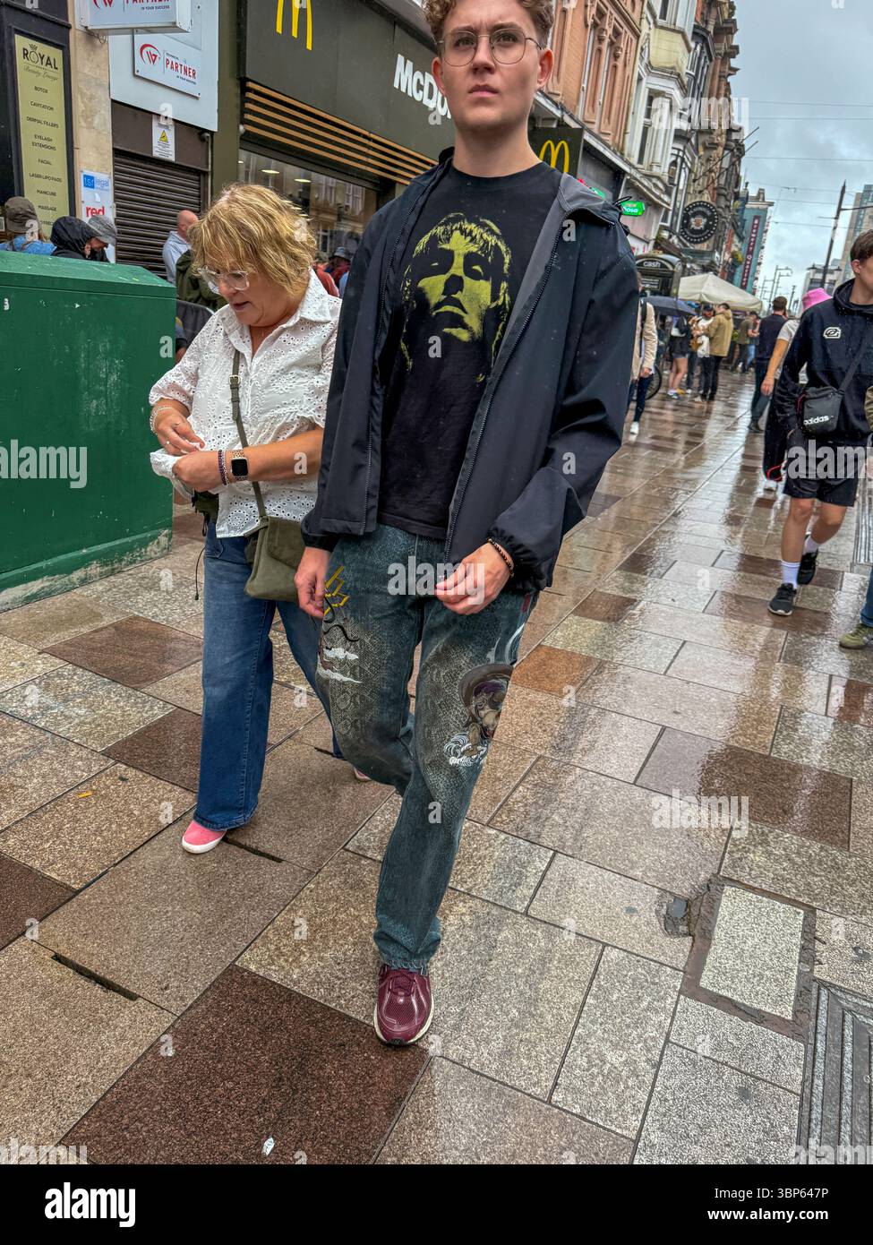 Oasis Fans and Buskers in Cardiff City Centre During Oasis Live ’25 Reunion Tour - Smartphone Captured Stock Image