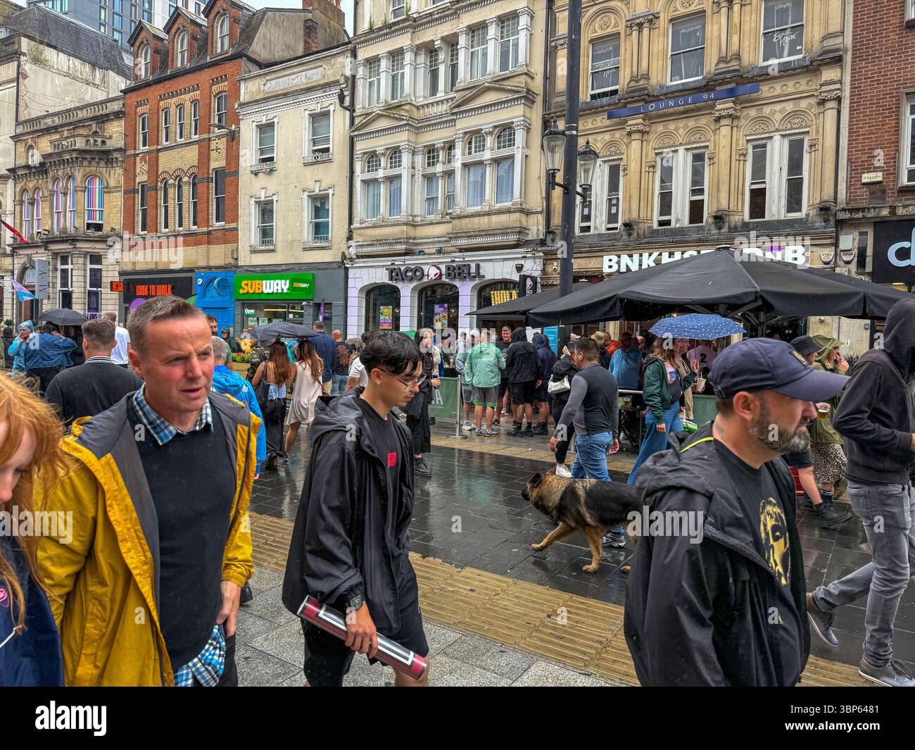 Oasis Fans and Buskers in Cardiff City Centre During Oasis Live ’25 Reunion Tour - Smartphone Captured Stock Image