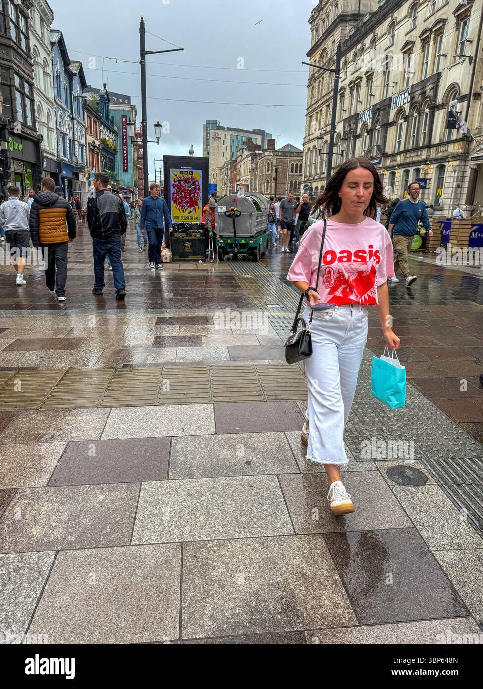 Oasis Fans and Buskers in Cardiff City Centre During Oasis Live ’25 Reunion Tour - Smartphone Captured Stock Image