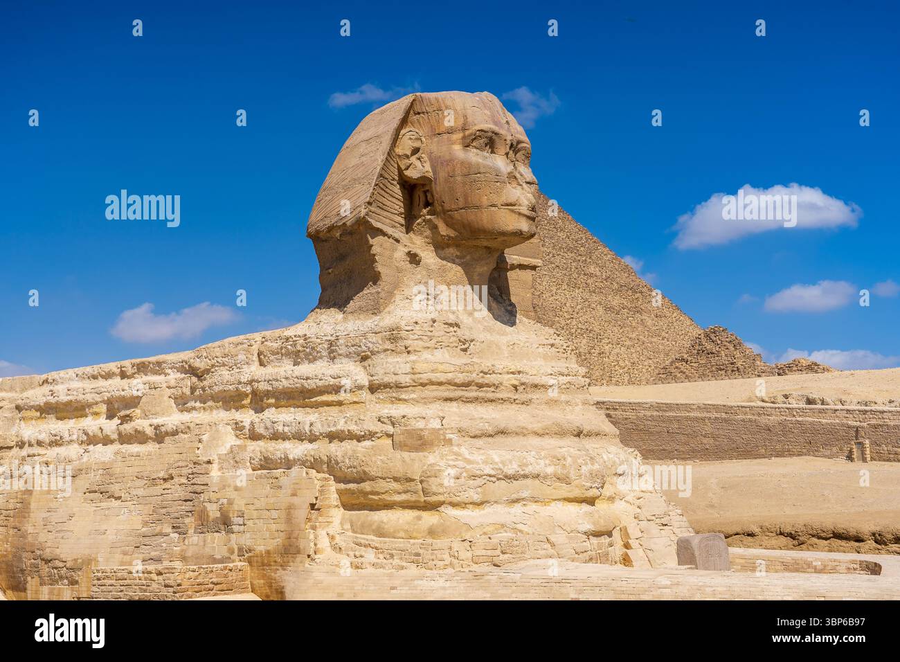 View of the Sphinx, behind which is the pyramid of Cheops Stock Photo ...