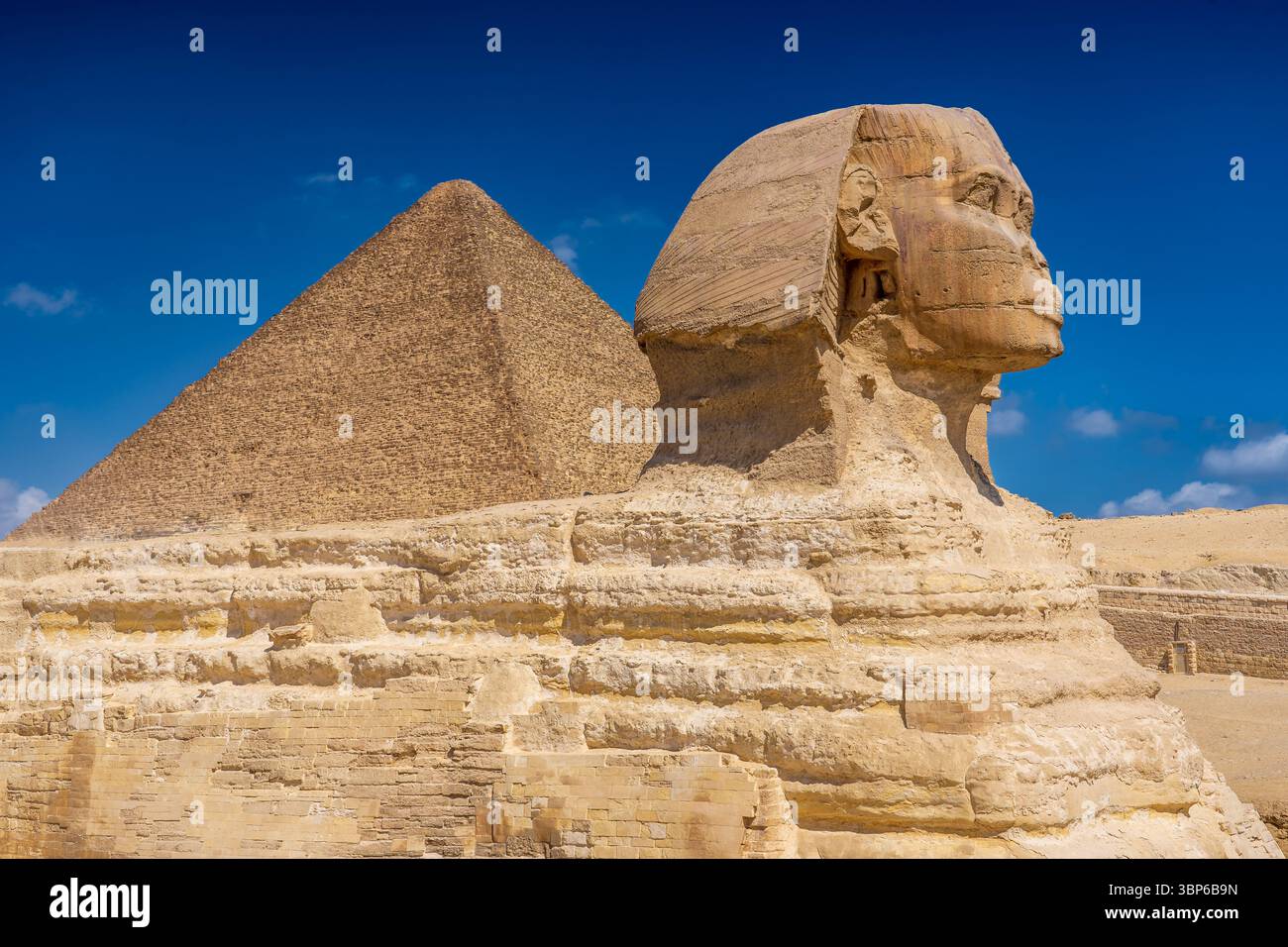 View of the Sphinx, behind which is the pyramid of Cheops Stock Photo ...
