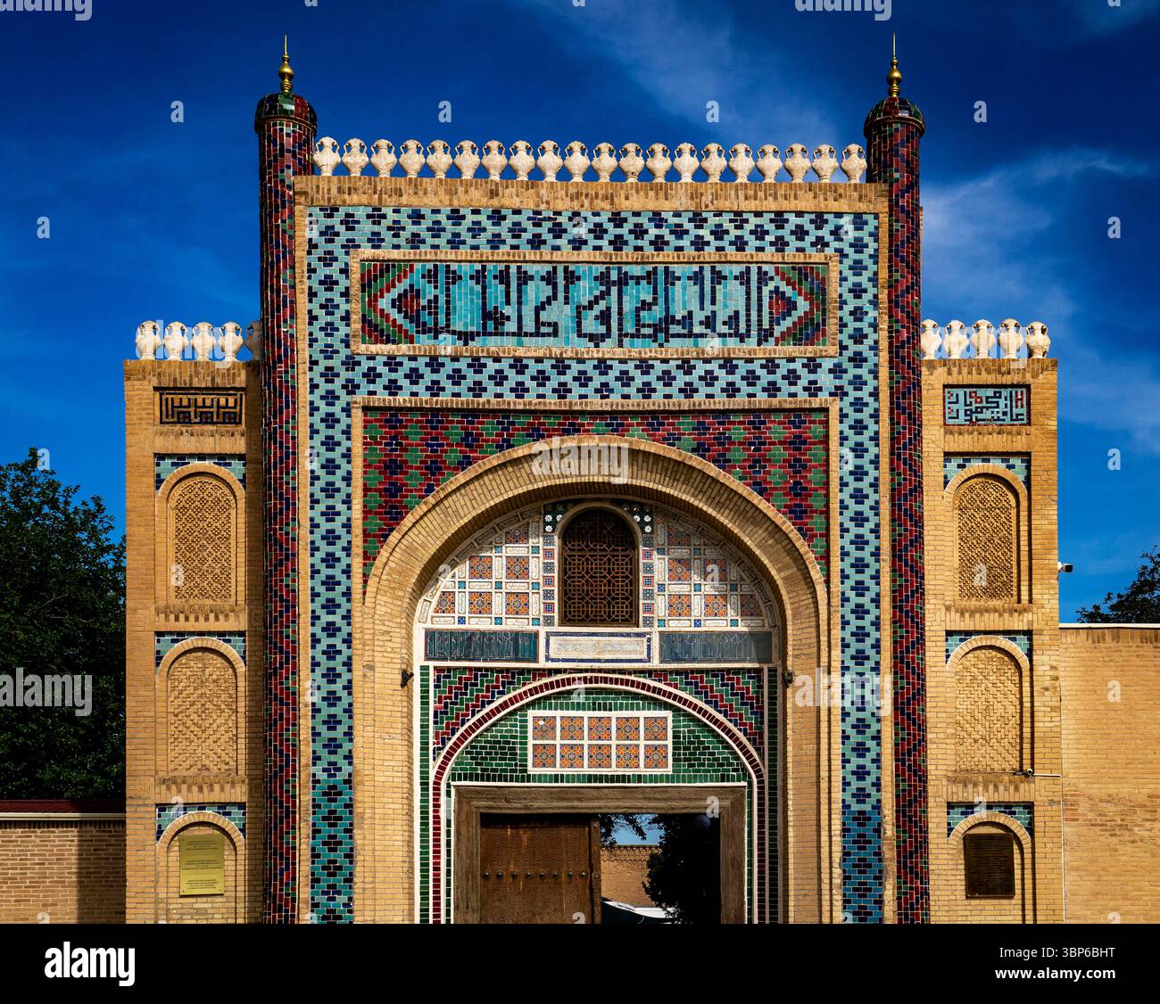 A stunning architectural entrance featuring intricate tile work and vibrant colors, showcasing traditional patterns and designs. The structure is fram Stock Photo
