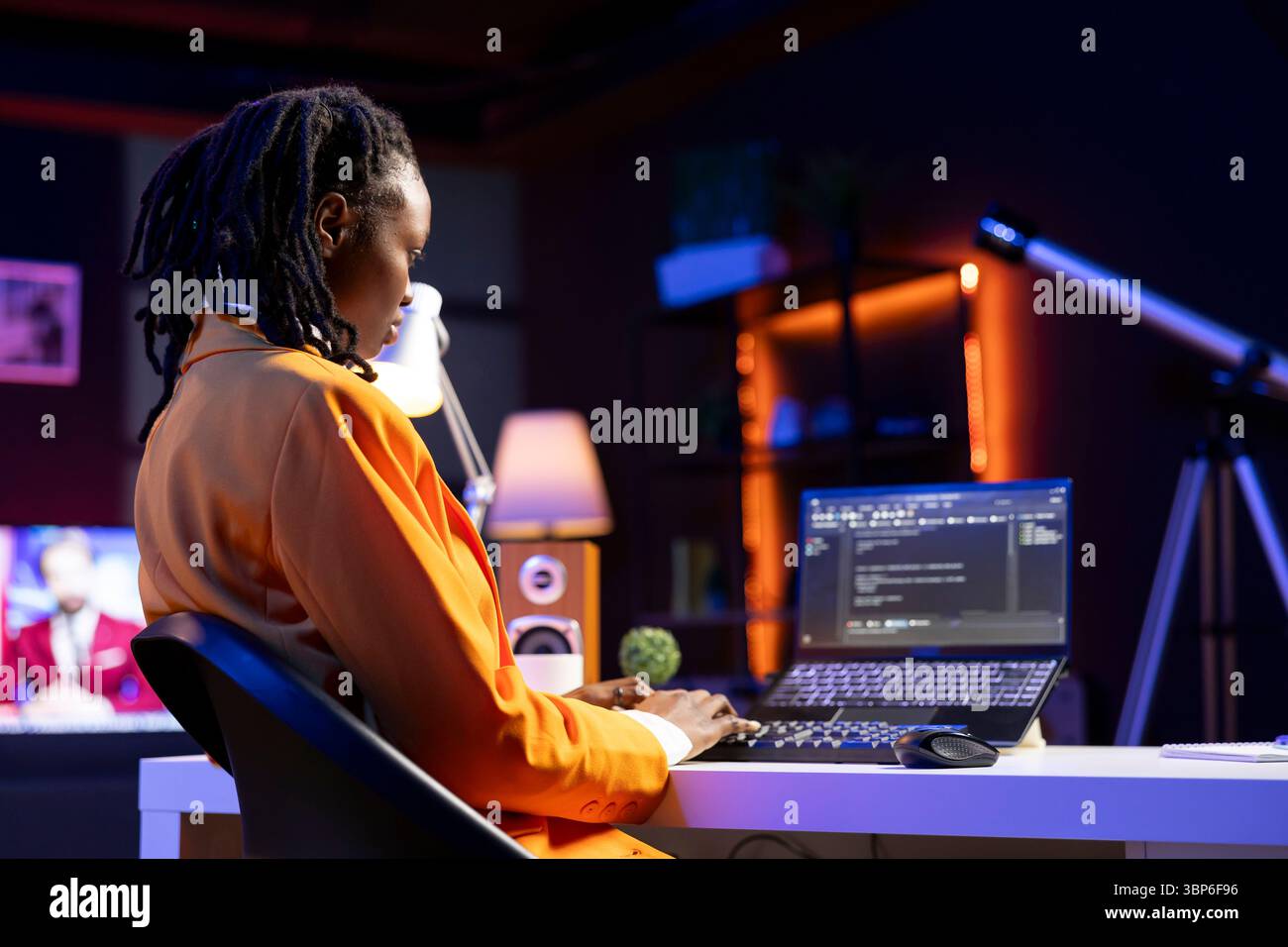 Freelancing admin in home office using laptop to write programming language code. Young software technician working from apartment using notebook device to build application Stock Photo