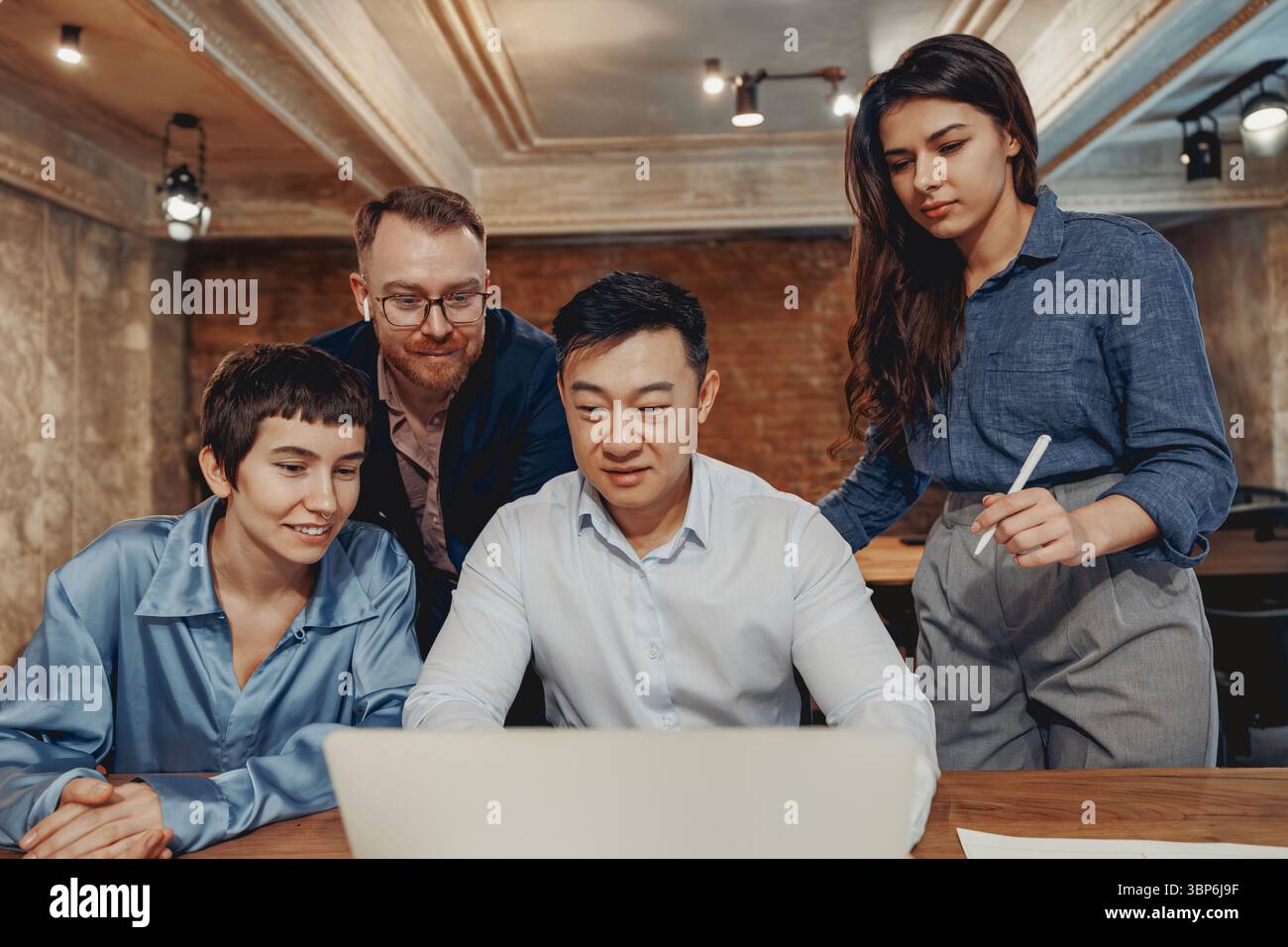 A Diverse Team Working Together Collaborating on a Project in a Modern ...