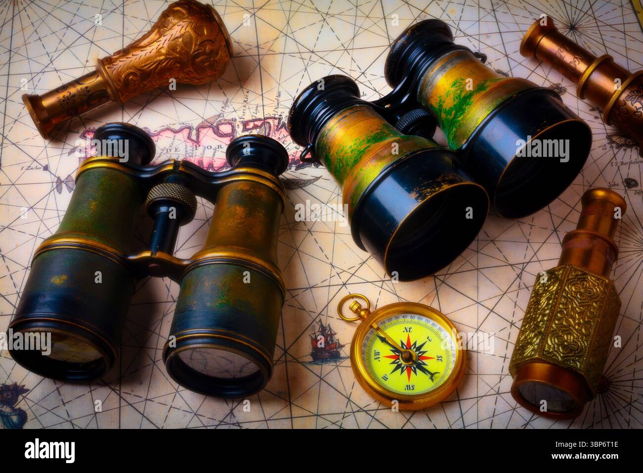Binoculars And Telescopes With Compas On Old Map Stock Photo
