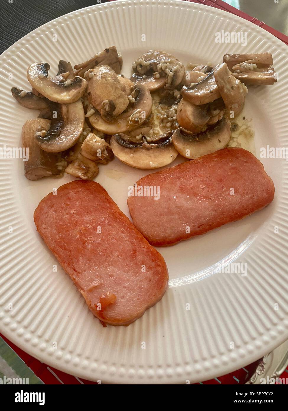 Still life of a main course meal of sliced spam and sautéed mushrooms, 2025, United States - Smartphone Captured Stock Image