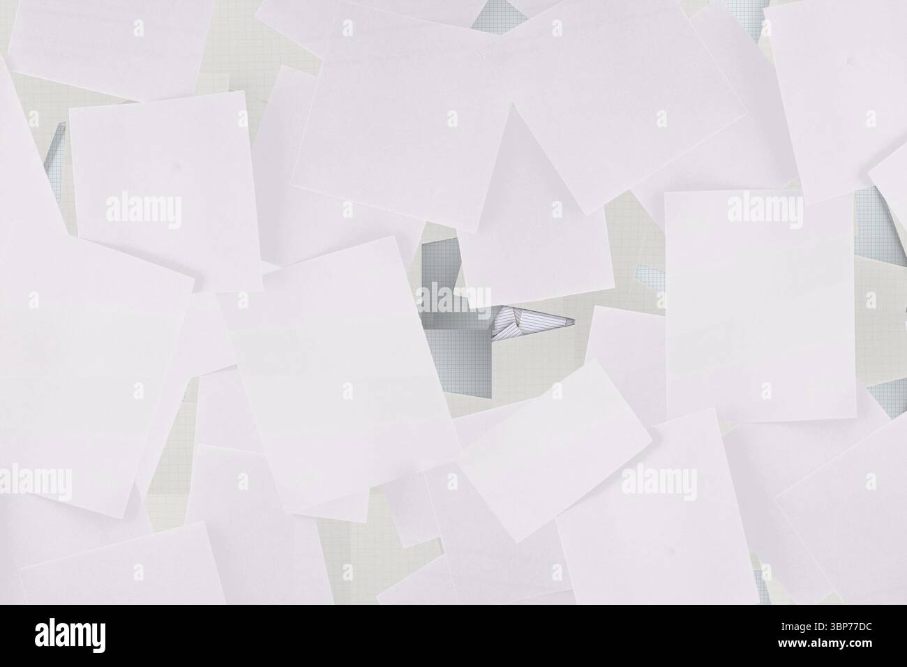 Flat design showing blank sheets scattering across workspace with grid mat, folded triangle Stock Photo