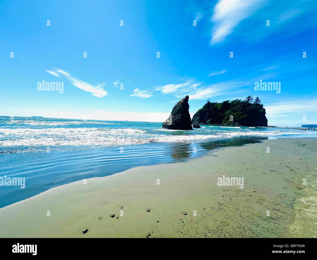 Scenic view of Ruby Beach on the Olympic Peninsula, Washington, featuring sea stacks, driftwood, and moody coastal skies at low tide. - Smartphone Captured Stock Image