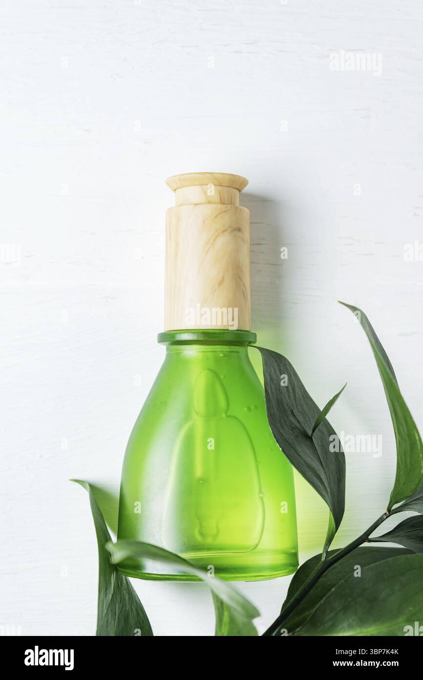 Natuerliche kosmetische Hautpflege Flasche mit Pipette und organischen gruenen Blatt auf weissem Hintergrund. Hausgemachte Heilmittel und Schoenheitsp Stock Photo