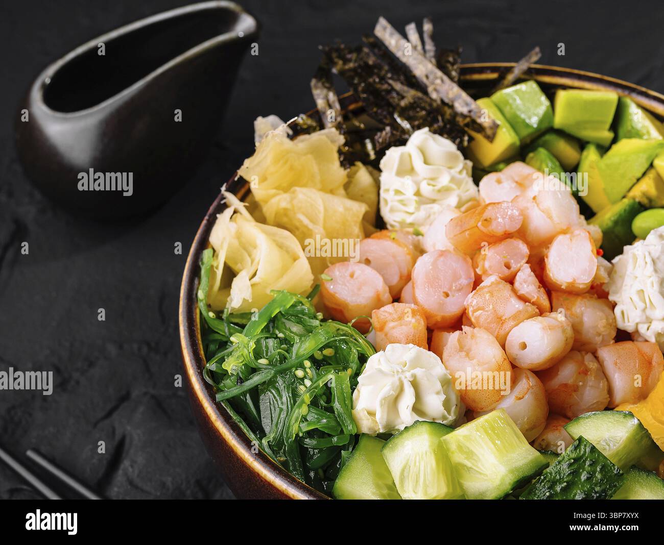 Food, Healthy poke bowl with shrimp, edamame, mango, seaweed, and vegetables, presented stylishly Stock Photo