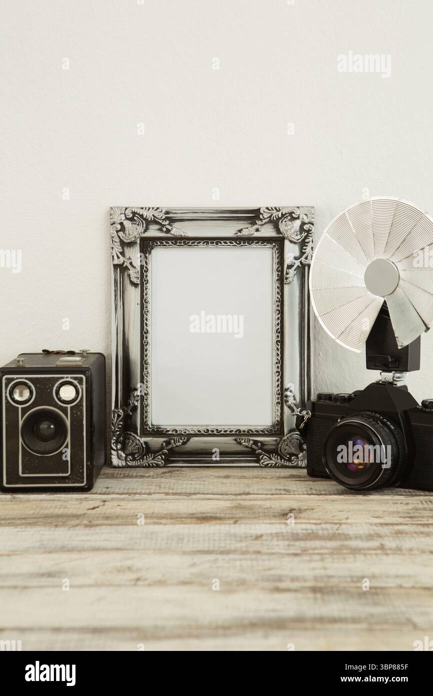 Photo frame, speaker and camera on table Stock Photo