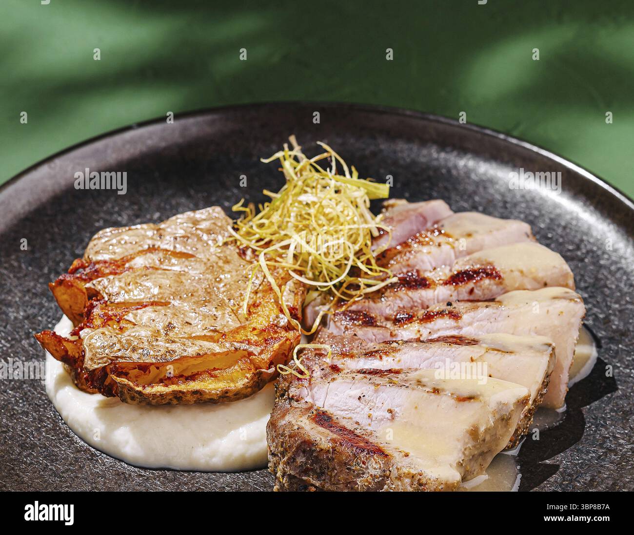 Food, A delicious grilled pork dish is presented on a dark plate ...