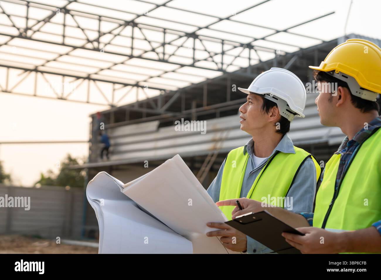 Engineers team use tablet and check the blueprint on site. Contractor ...