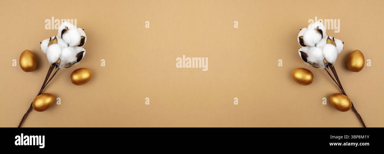 Festive easter banner. Cotton flower branch and gold painted eggs on beige background. Neutral colors Stock Photo