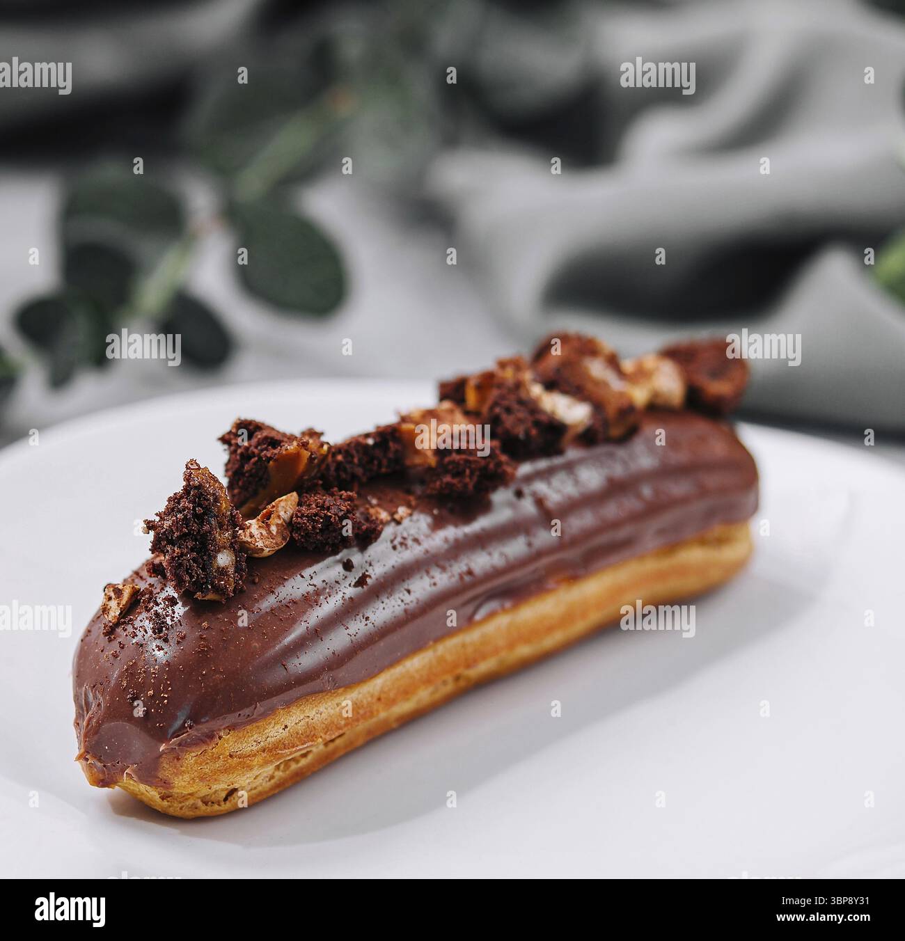 Food, Eclair with Chocolate Cream and Hazelnuts Stock Photo