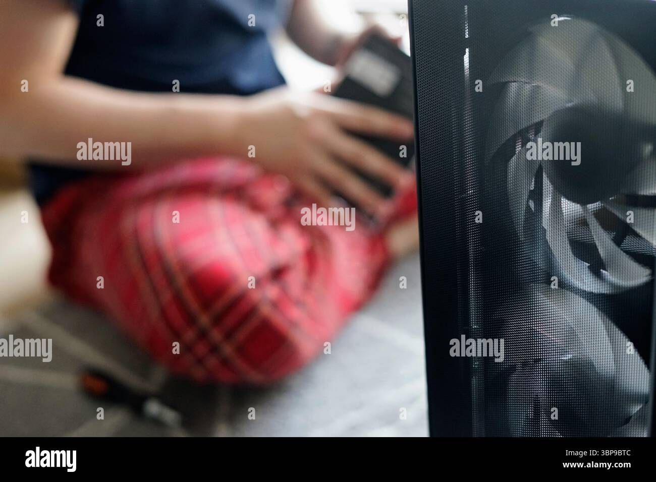 man repairing computer working home looking fixing broken engineer hardware pc service support Stock Photo