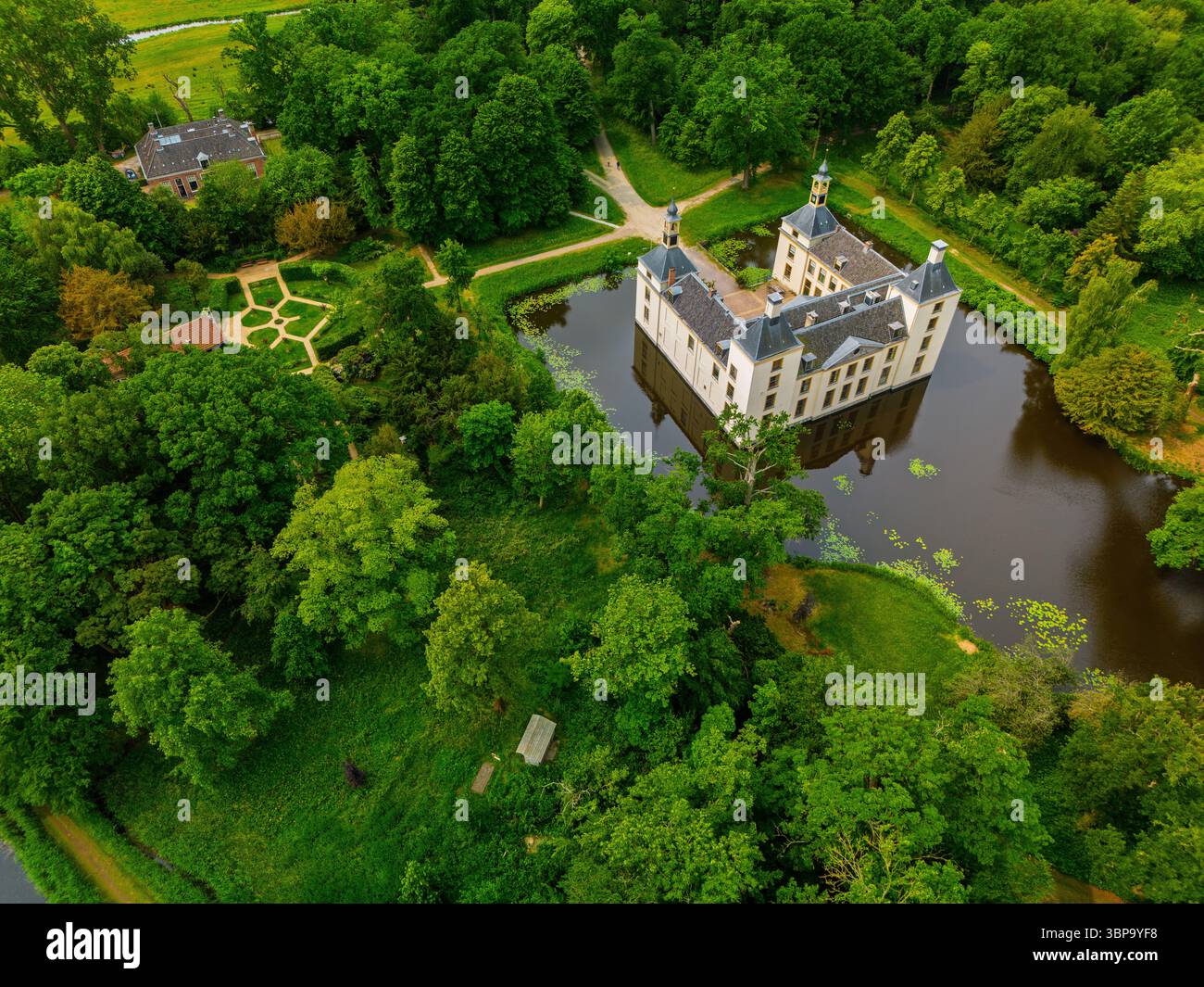 Aerial view of a historic castle surrounded by a forest, with vast ...