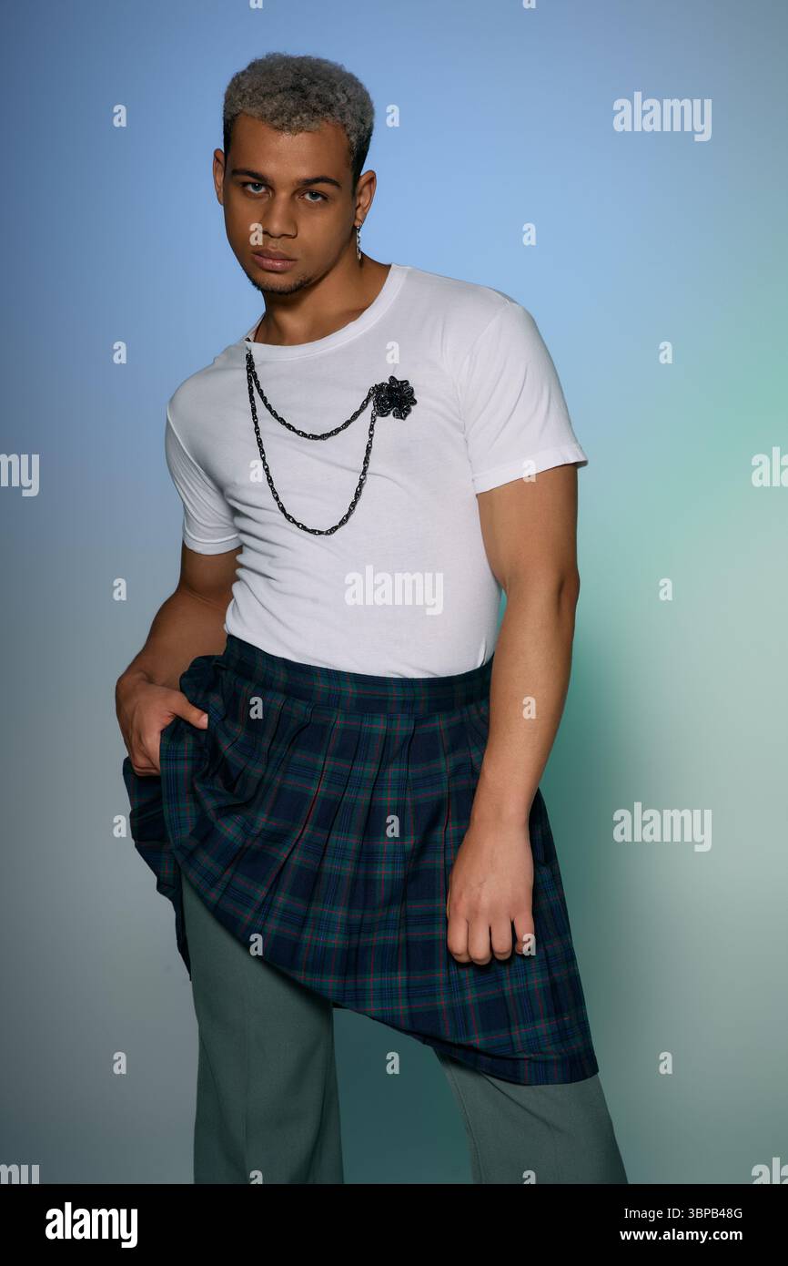 A young Black man showcases confidence in a trendy outfit, celebrating ...