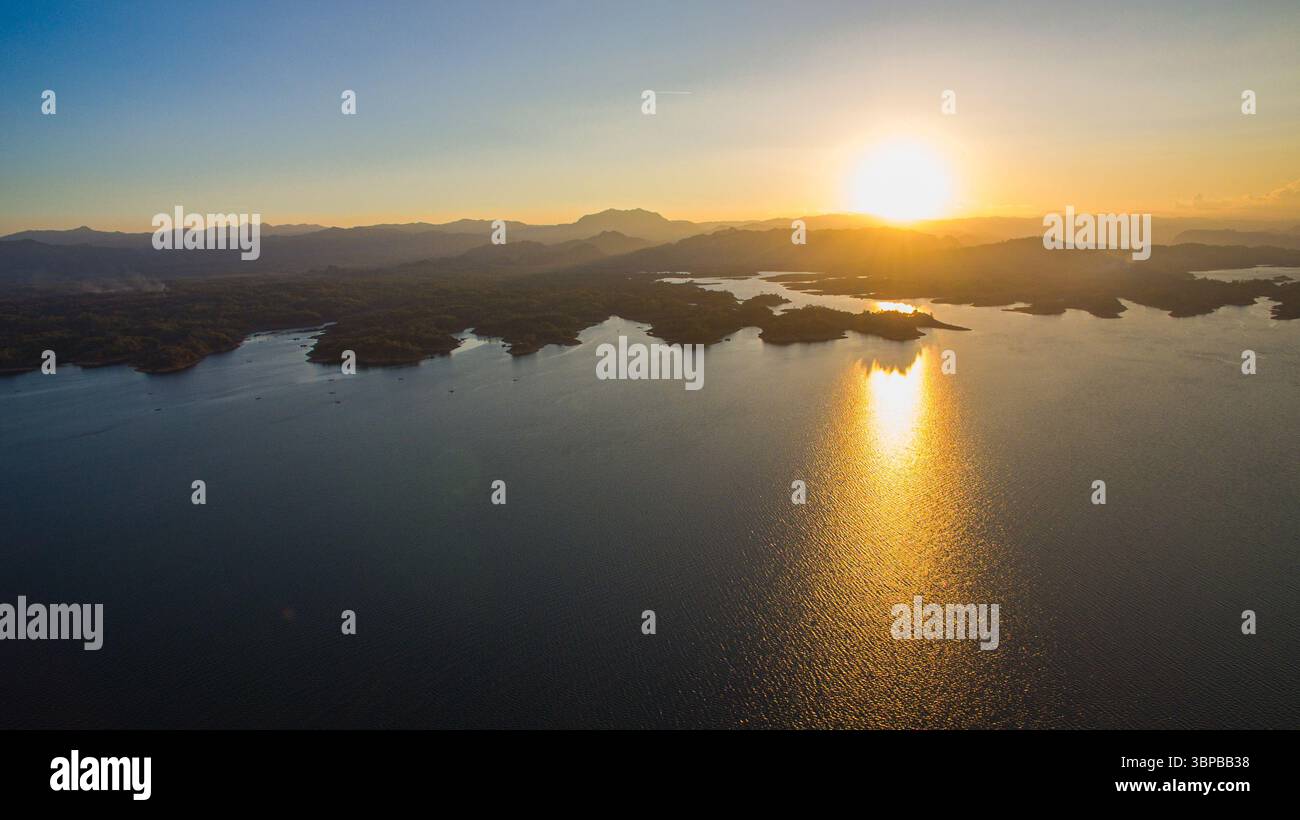 stunning aerial scene captures the meeting point of rugged mountains and endless lake. With vibrant cloudscapes and scattered islands, Vajiralongkorn Stock Photo
