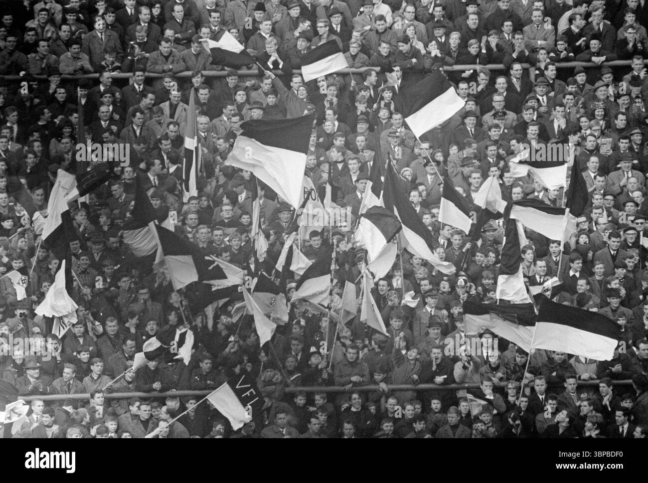 Sixties, sports, football, Bundesliga, 1966/1967, Borussia Moenchengladbach vs. Hamburger SV 4-2, 28.01.1967, Boekelberg Stadium in Moenchengladbach, spectators, football fans wave the club flags and have fun Stock Photo