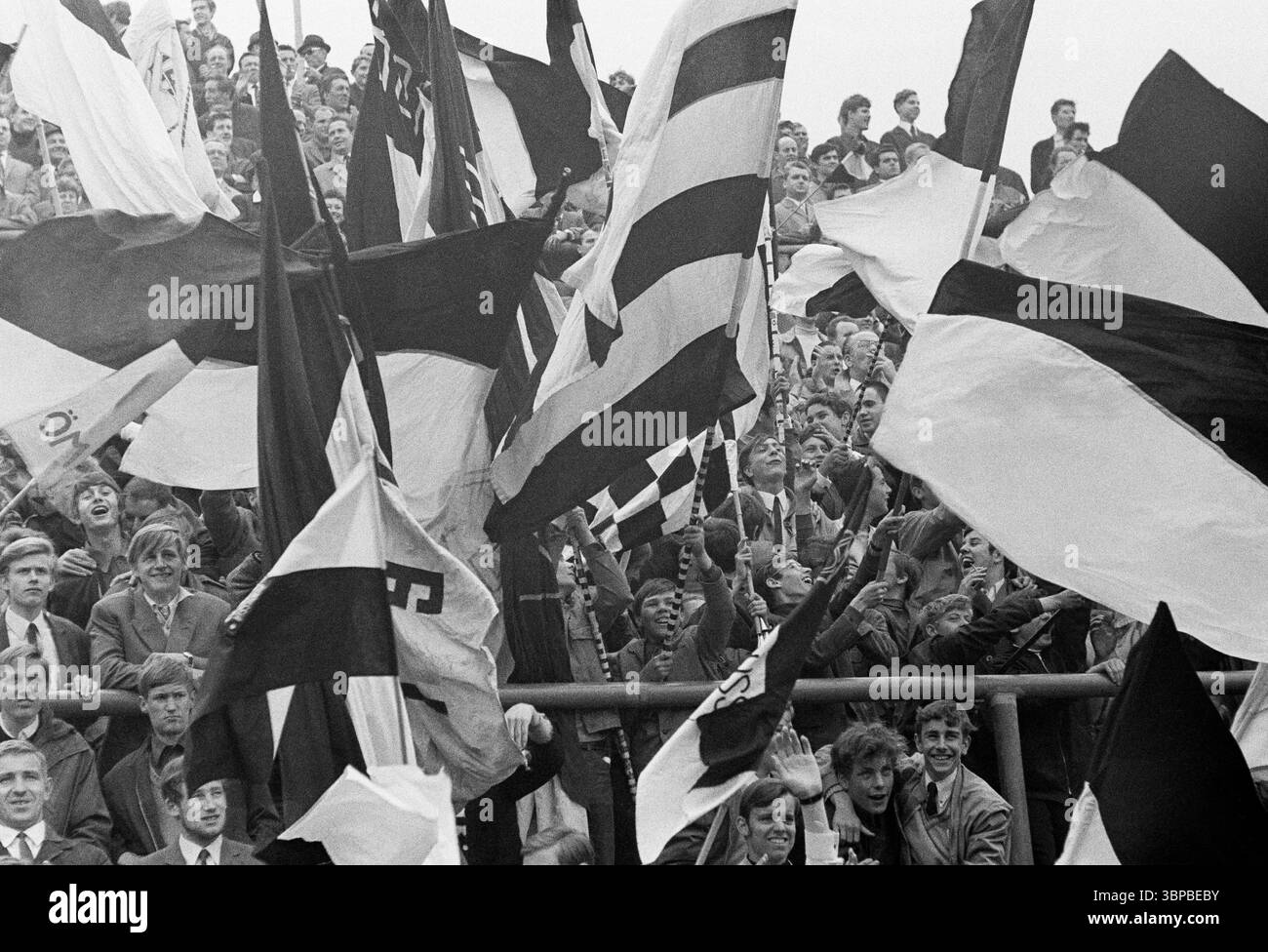 Sixties, sports, football, Bundesliga, 1967/1968, Borussia Moenchengladbach vs. 1. FC Koeln 1-0, 11.05.1968, Boekelberg Stadium, Gladbach fans in the Nordkurve have fun and wave the club flags Stock Photo