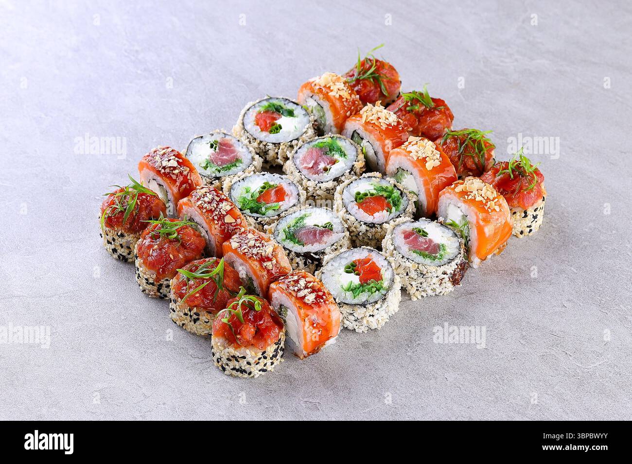 Premium Salmon Sushi Roll Set on Gray Stone Background Plate Stock Photo