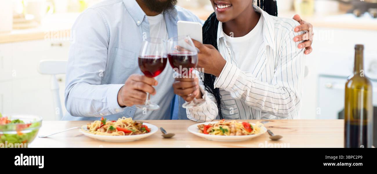 Young Black Lovers Taking Photos On Smartphone While Having Date At Home Stock Photo