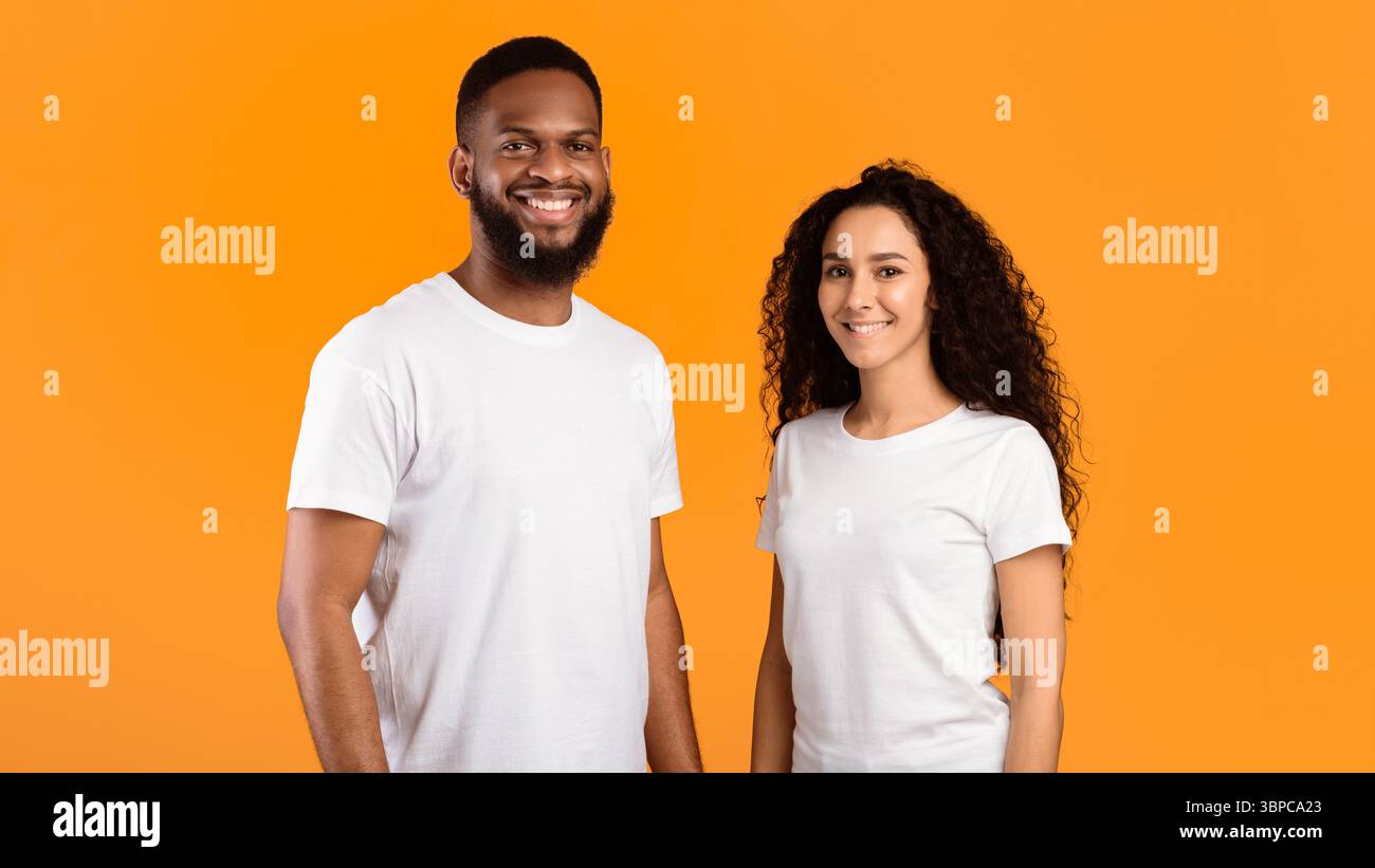 Multiethnic Couple Posing Standing Over Yellow Studio Background, Panorama Stock Photo