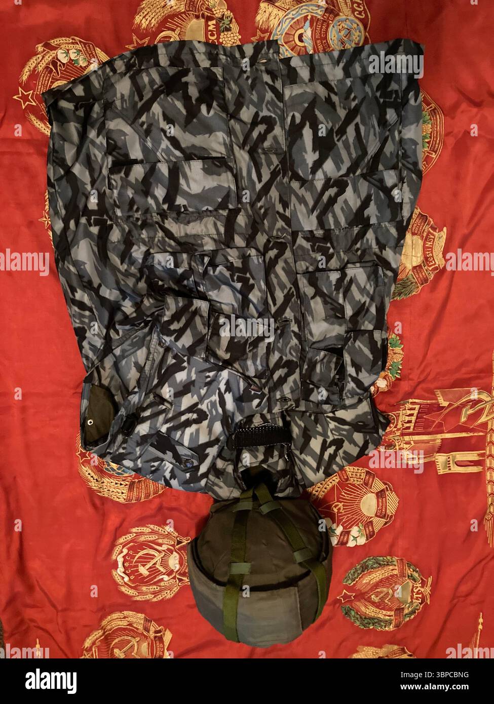 STSh-81 Titanium Helmet and NPO-SM Urban Reed Camouflage Vest on Soviet Banner - Smartphone Captured Stock Image