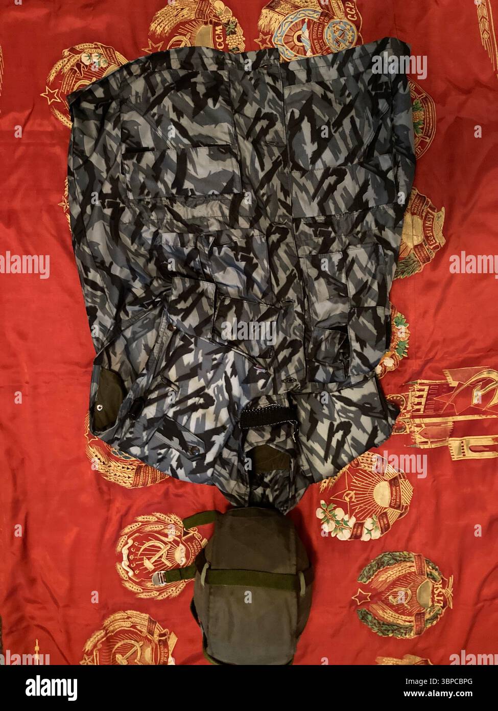 STSh-81 Titanium Helmet and NPO-SM Urban Reed Camouflage Vest on Soviet Banner - Smartphone Captured Stock Image