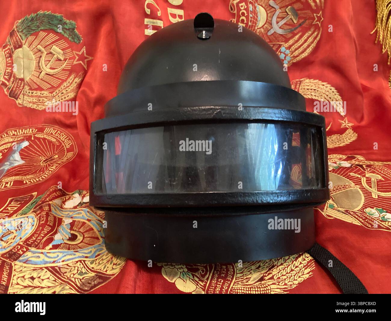 Black K6-3 Russian Ballistic Helmet on Soviet Banner - Smartphone Captured Stock Image Black K6-3 Russian Ballistic Helmet on Soviet Banner - Smartphone Captured Stock Image