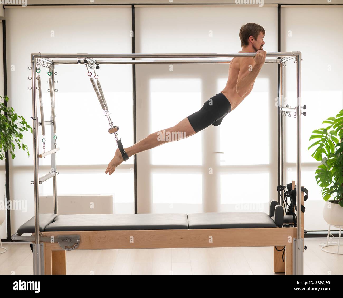 Reformer Reverse Fly Exercise Instructor exercises on reformer hi-res stock photography and images ...