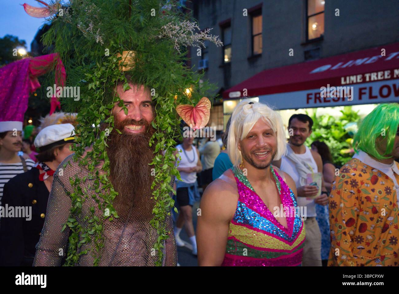 Two men in elaborate costumes at an outdoor event. One wears a ...