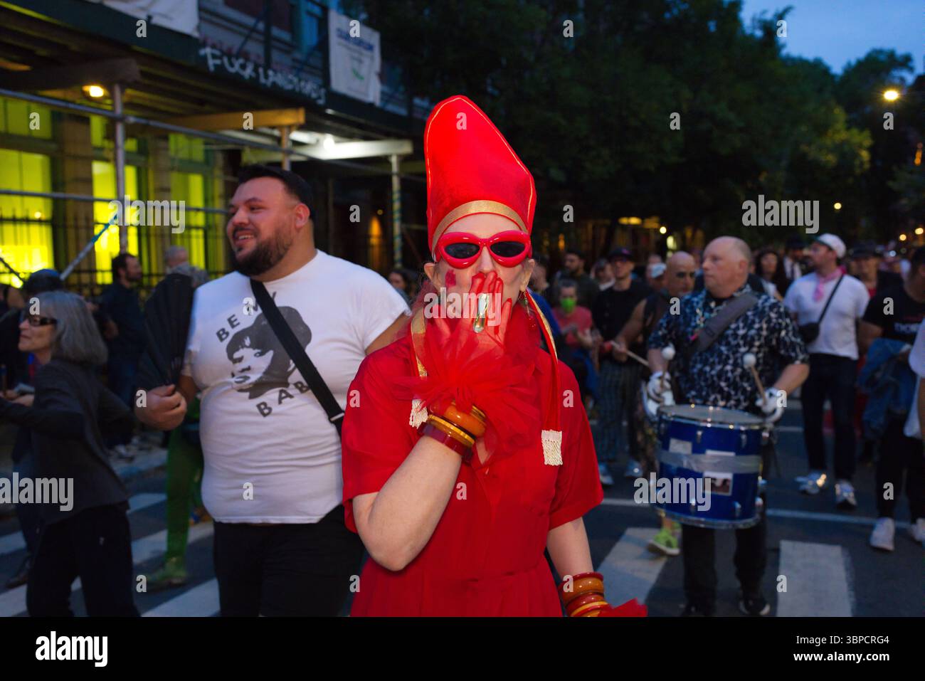 Person In Red A person in a vibrant red outfit and hat, wearing red gloves and ...