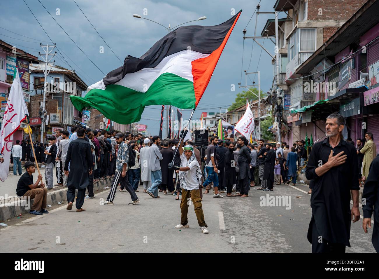 A Kashmiri Shia Muslim waves a Palestinian flag as he takes part in the ...
