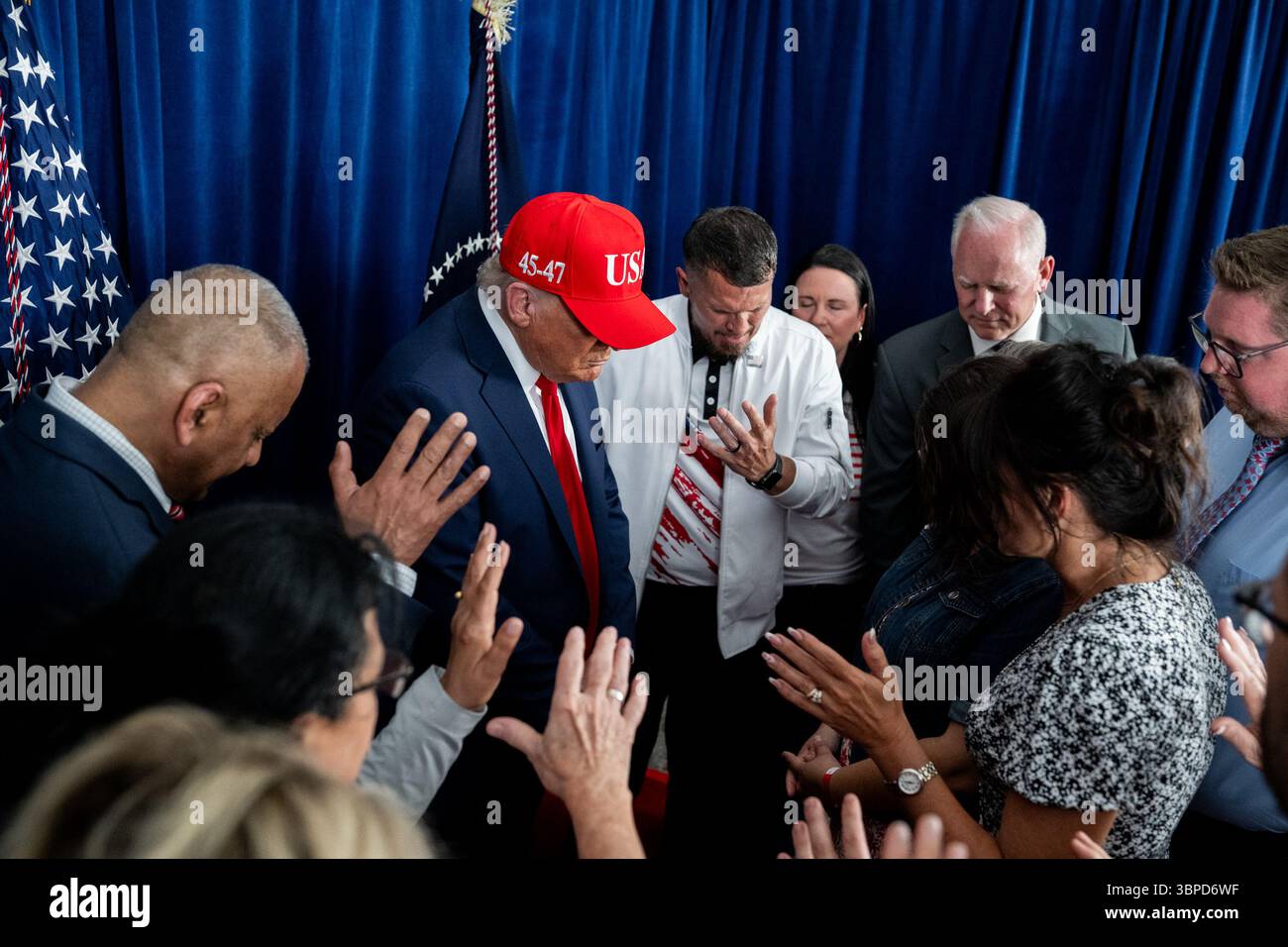 President Donald Trump participates in a prayer before a rally in Des ...