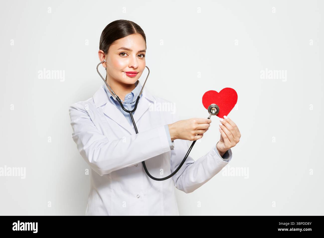 Young female doctor cardiologist with stethoscope over neck showing ...