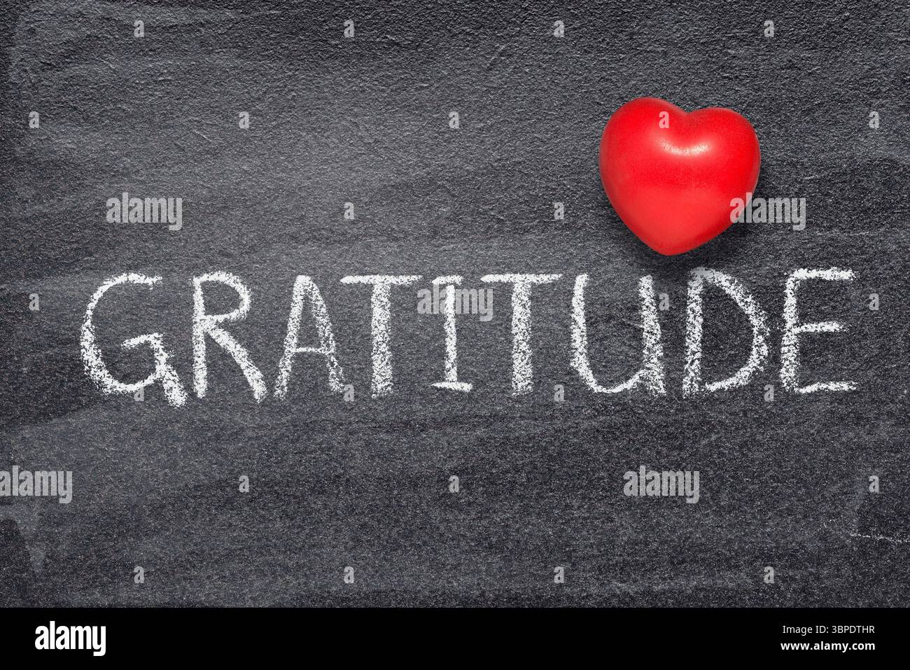 gratitude word handwritten on chalkboard with red heart symbol Stock Photo