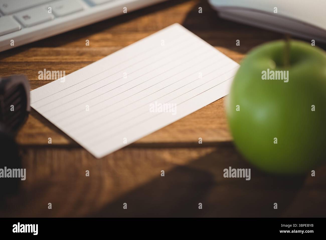 Keyboard and mouse by apple on table Stock Photo