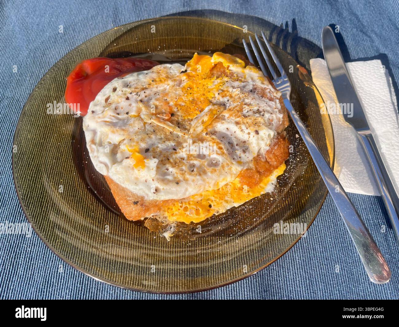 Fried egg breakfast sandwich and ketchup in glass plate - Smartphone Captured Stock Image