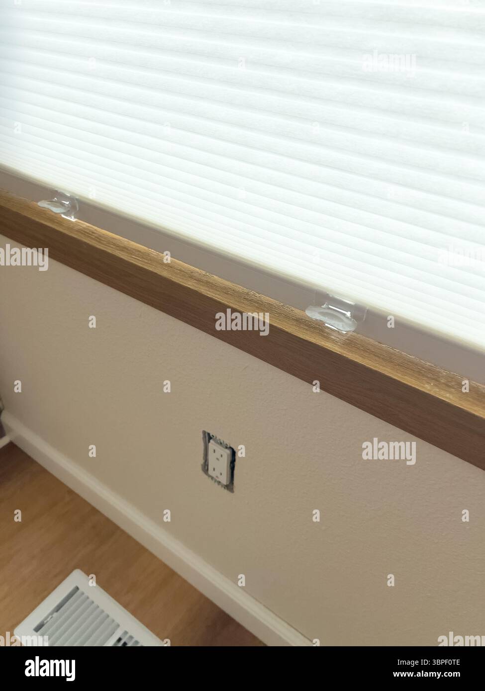 Interior wall with window and baseboard outlet Stock Photo - Alamy