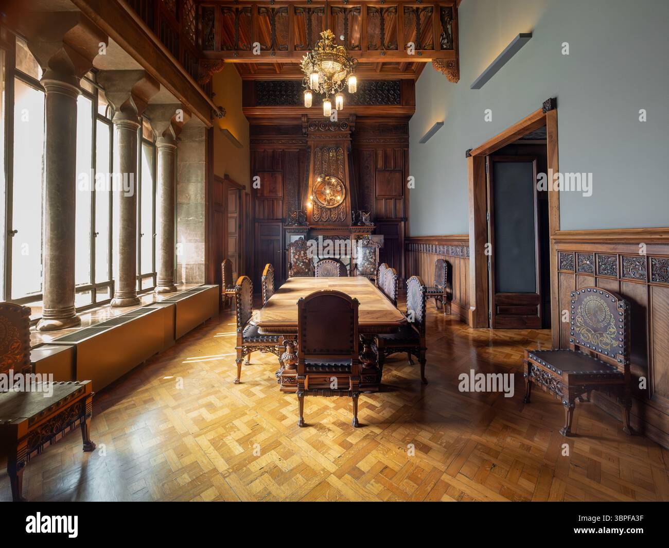 The opulent formal dining room of Palau Güell, with its original carved ...
