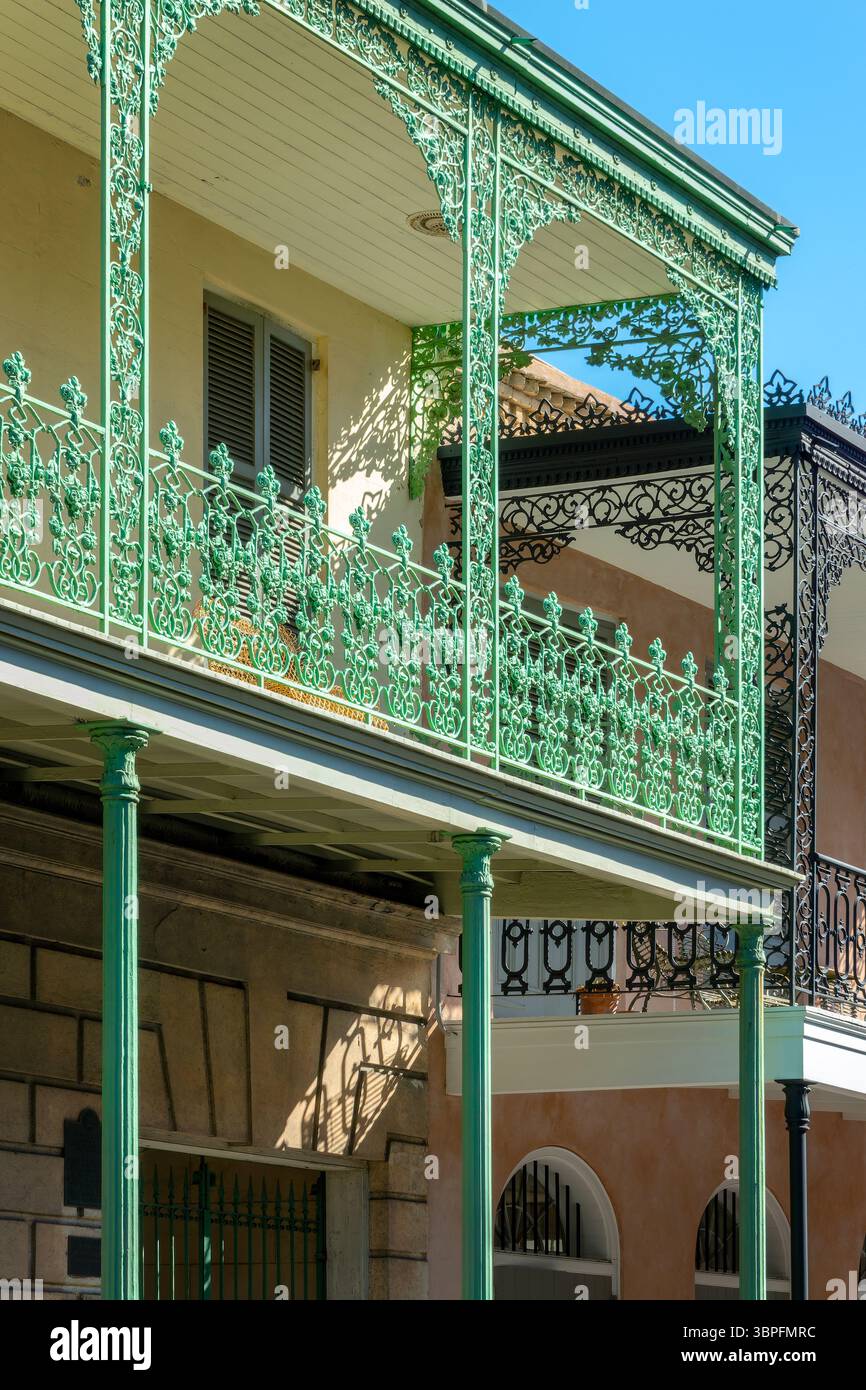 Balconies with intricate ironwork on a building in a street of the ...