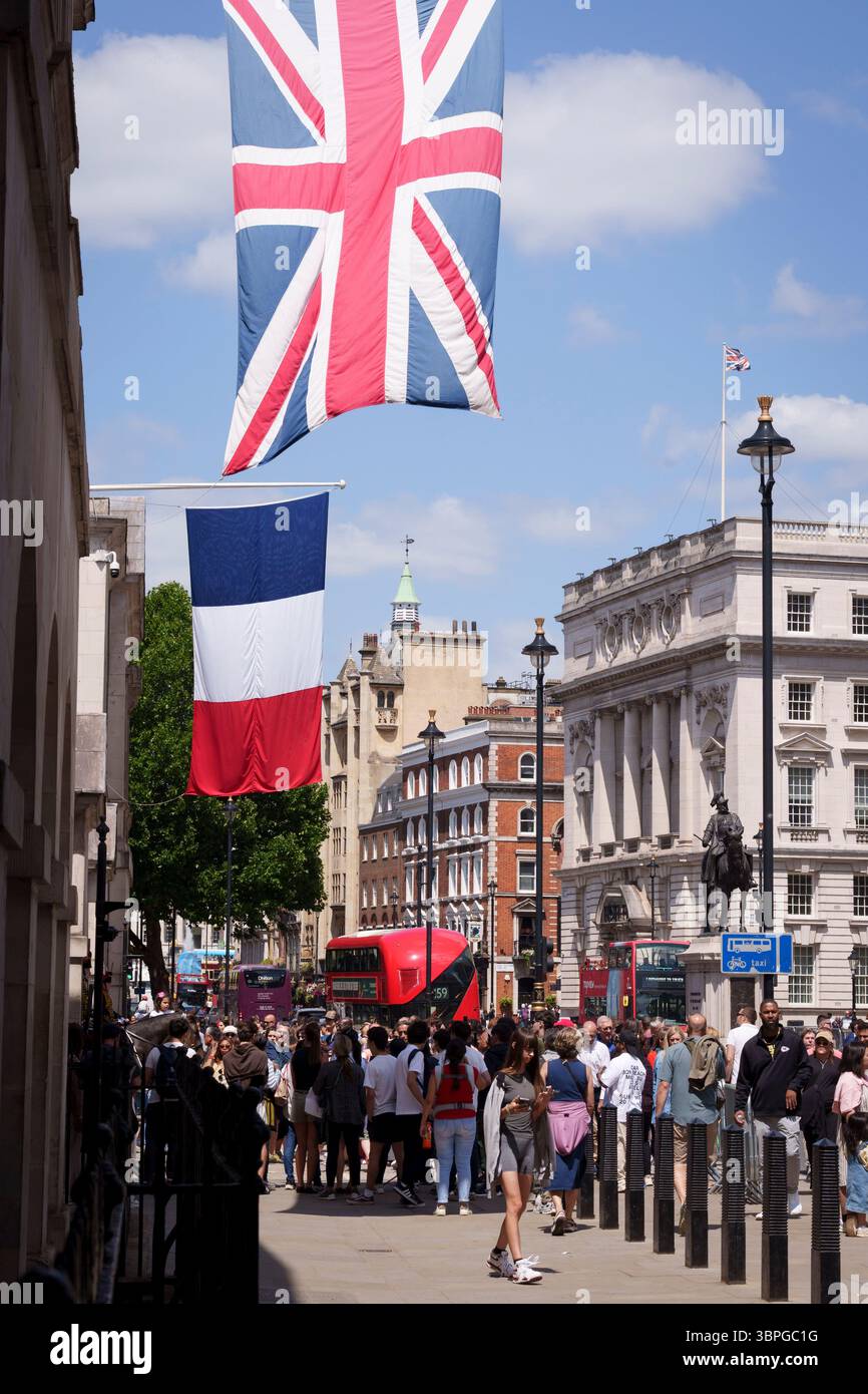 As French President Emmanuel Macron starts his state visit to the UK, the British Union Jack and the French Tricolore flags hang over Whitehall, on 8th July 2025, in London, England. Stock Photo