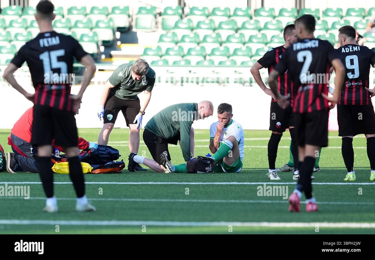 The New Saints' Leo Smith (centre) is treated for an injury by medical ...