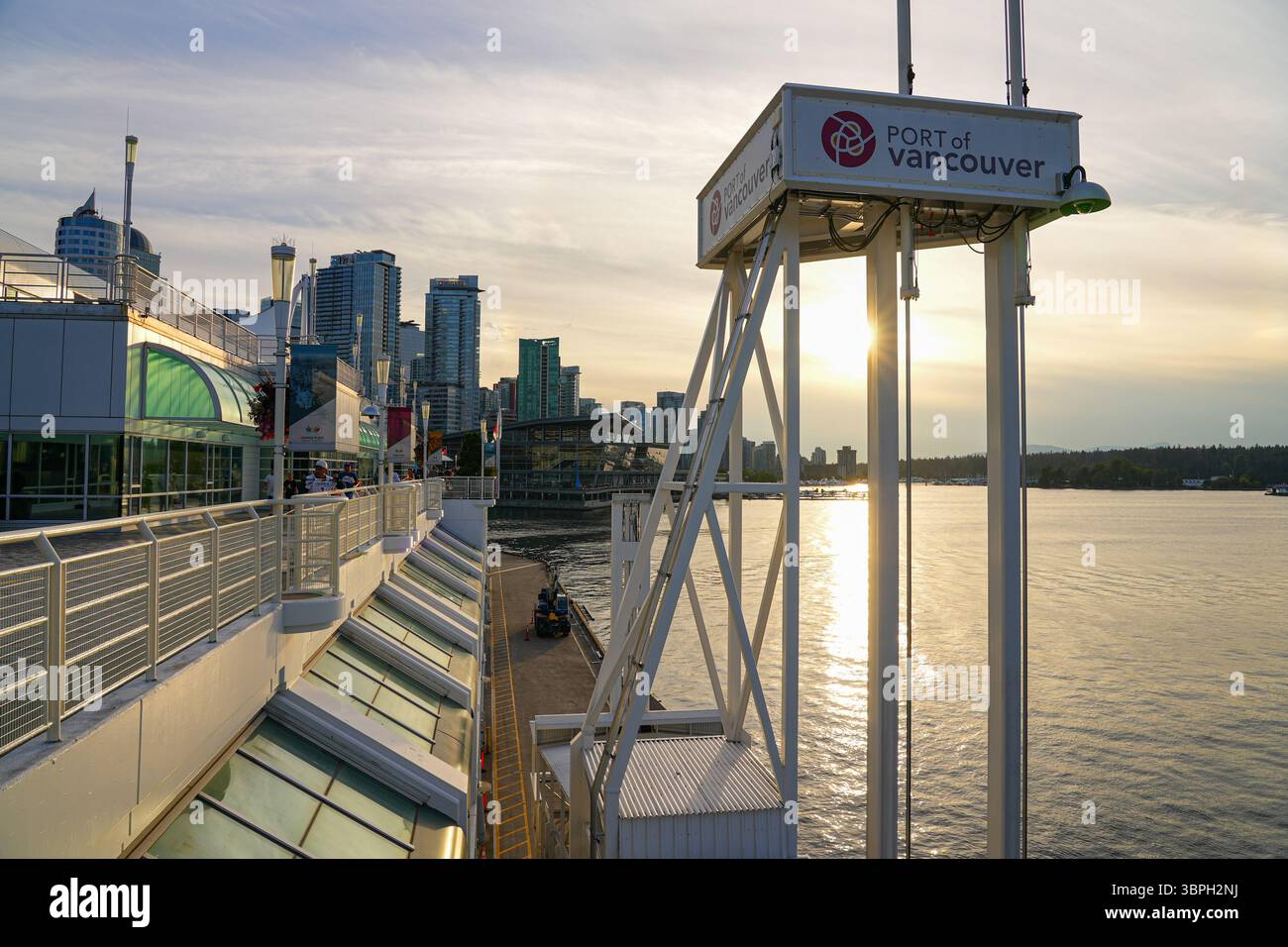 Sunset behind the tower of the Port of Vancouver in Canada Place, a Convention Centre and Cruise Ship Terminal in Downtown Vancouver, British Columbia Stock Photo