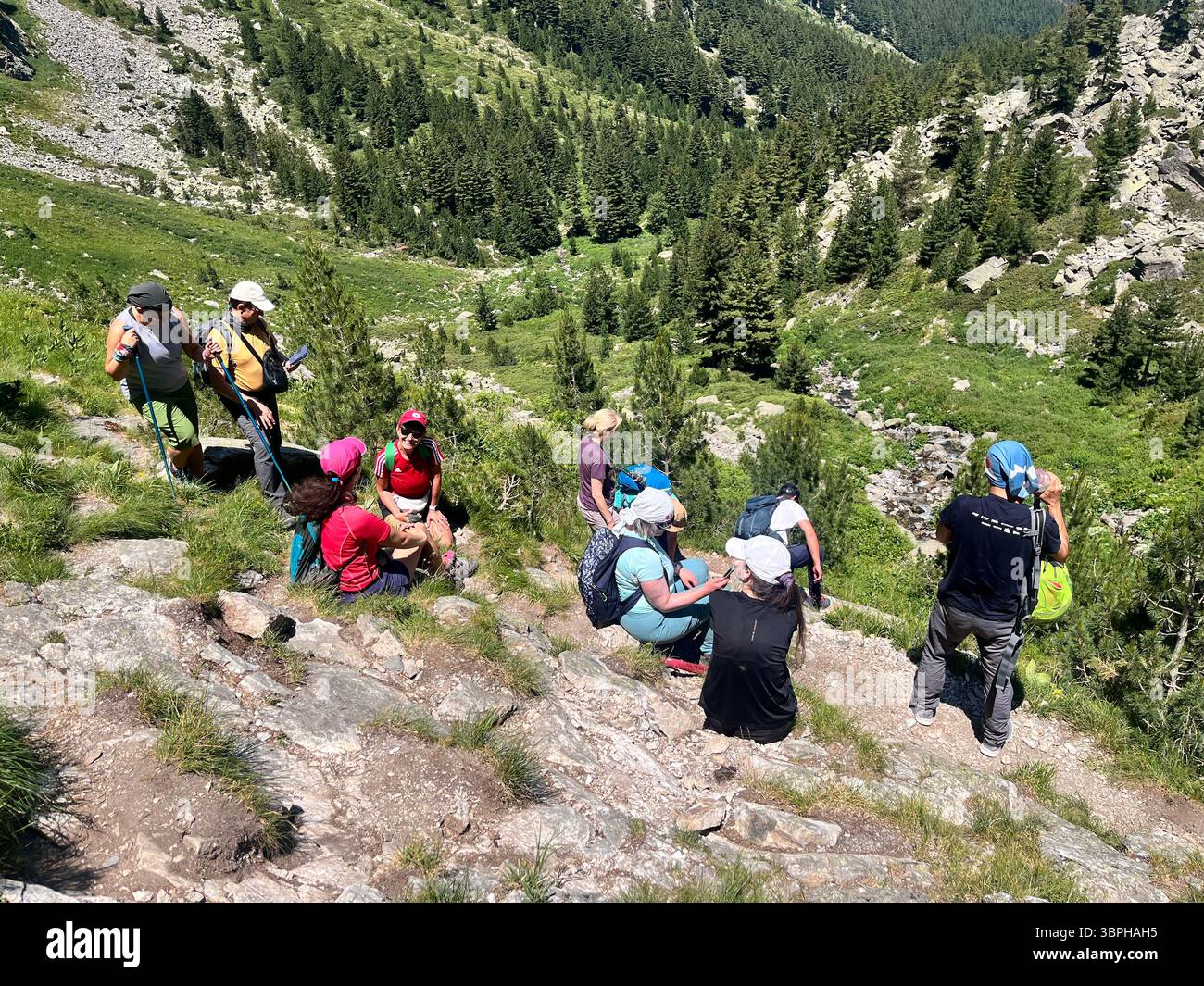 Group of hikers resting while hiking the Skakavitsa Nature Reserve in Rila National Park, Rila Mountain, Bulgaria, Balkans, Southeastern Europe - Smartphone Captured Stock Image